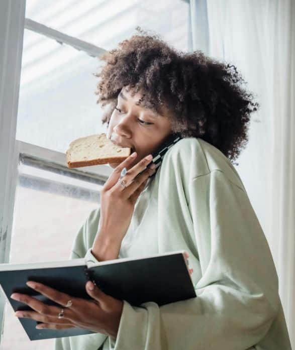 Woman eating and working